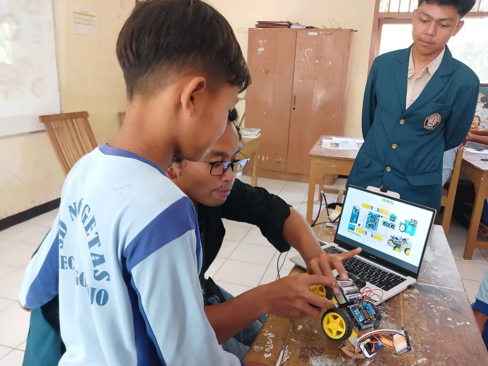 A group of boys working on a computer AI-generated content may be incorrect.